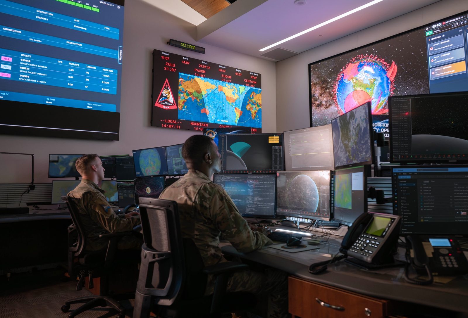 U.S. Space Force Guardians monitoring workstations in a space operations center